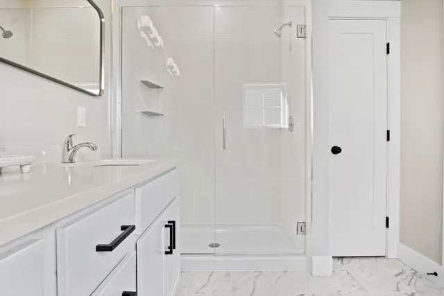 a bathroom with a shower and a sink