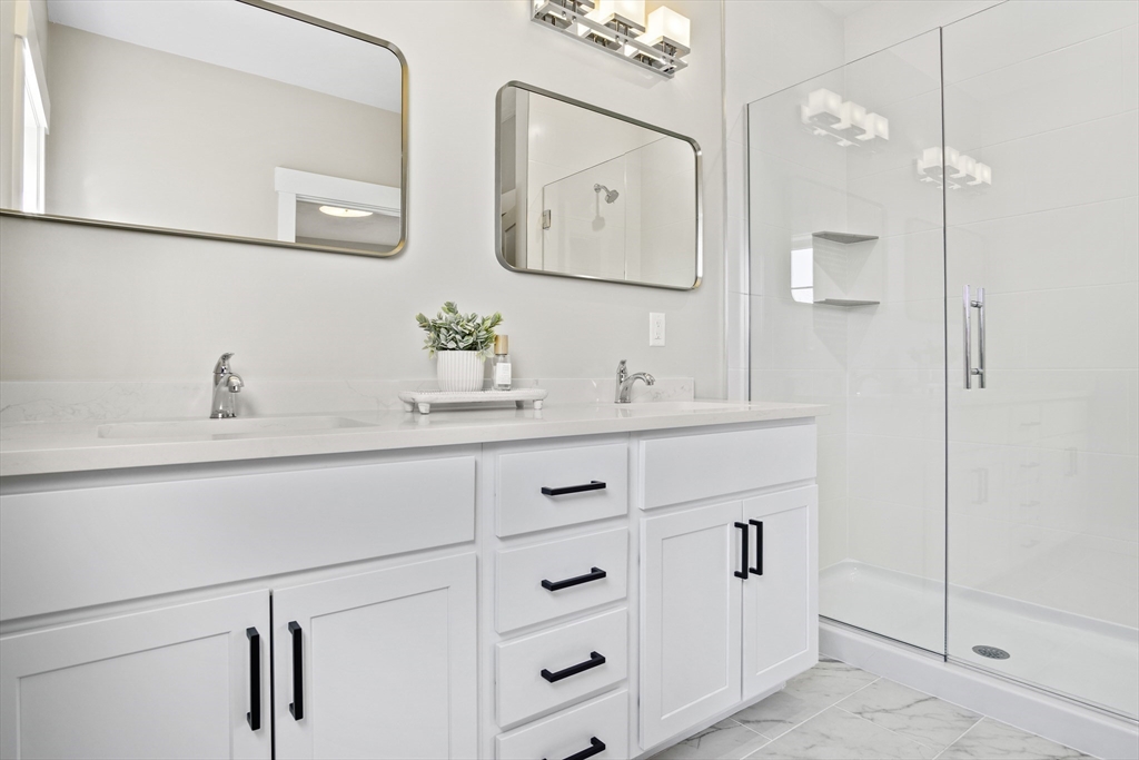 25 Salisbury Hill Boulevard, Unit 67 Worcester, MA 01609 - Photo 20 of 42 a bathroom with a sink and mirror