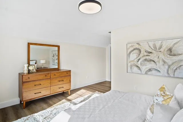 a bedroom with a bed and a dresser