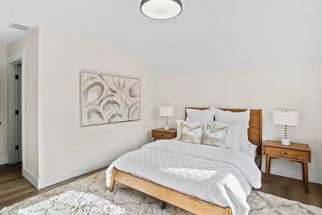 a bedroom with a bed and a night stand