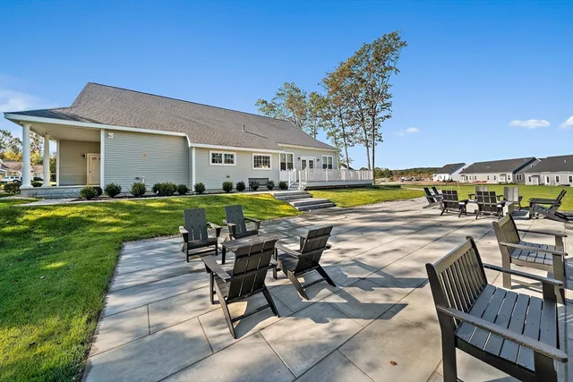 a view of a house with swimming pool and sitting area
