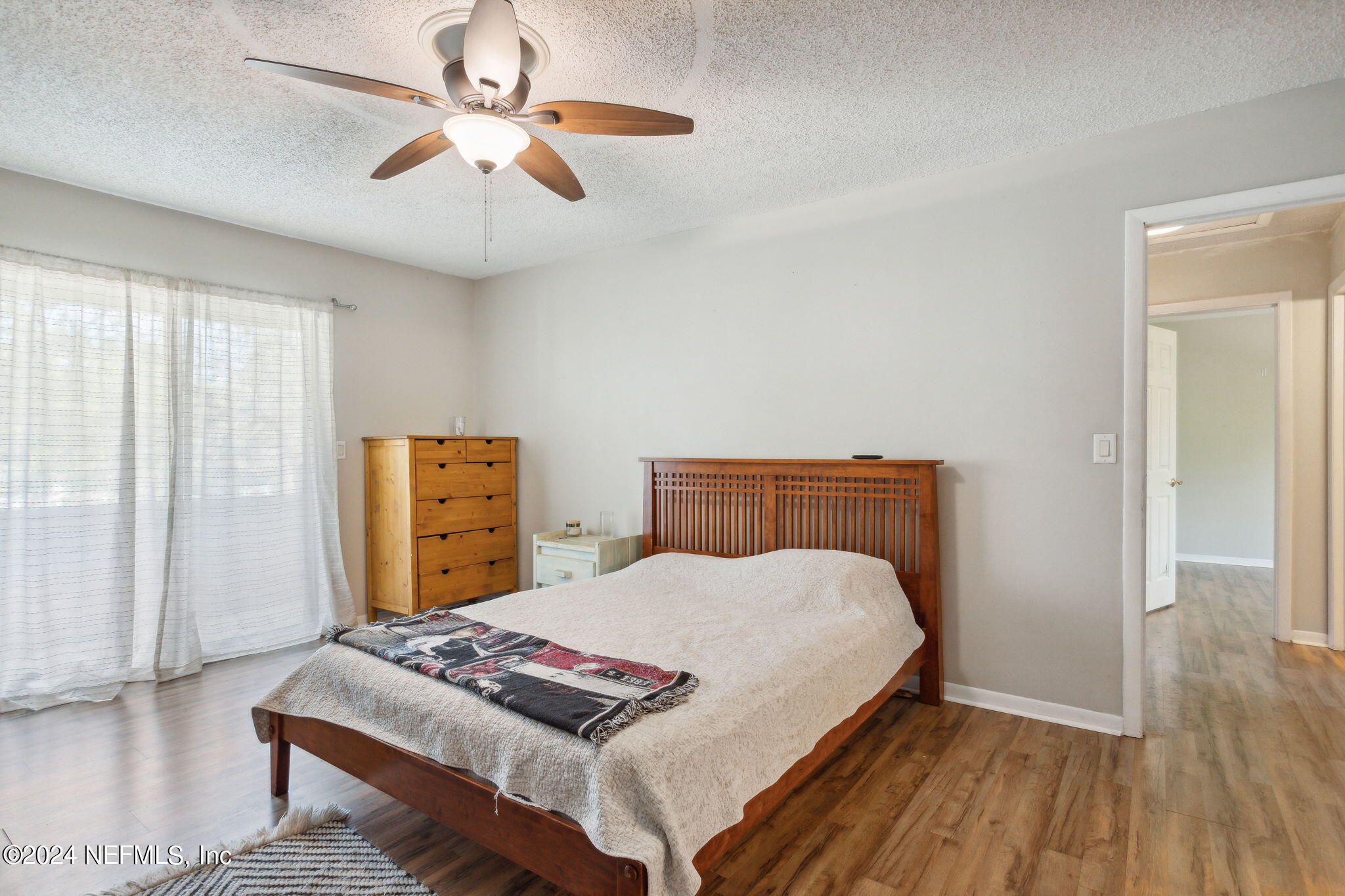 1154 Penman Road Jacksonville Beach, FL 32250 - Photo 11 of 20 a bedroom with a bed and a chandelier