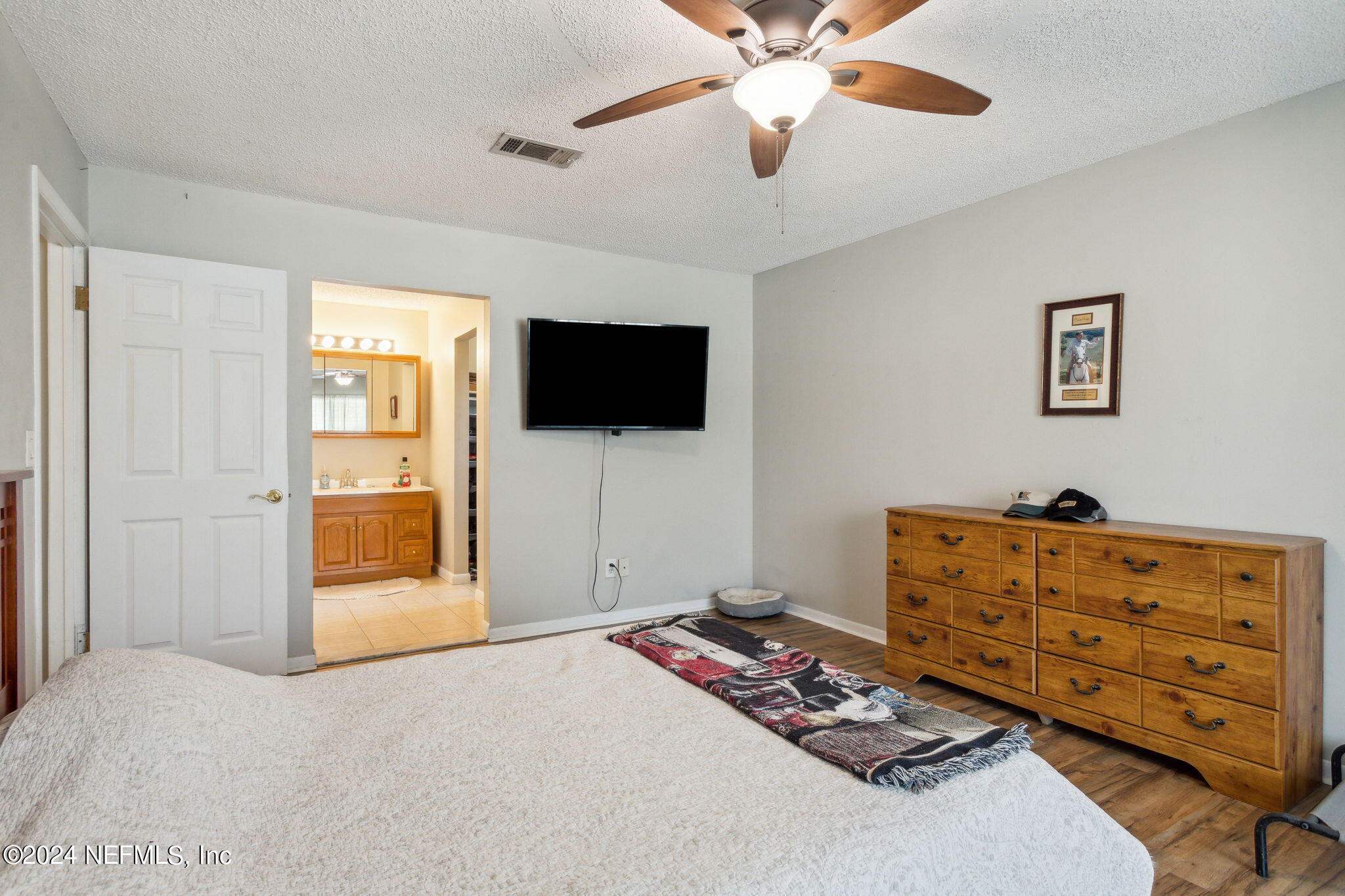 1154 Penman Road Jacksonville Beach, FL 32250 - Photo 13 of 20 a bedroom with a bed and a flat screen tv