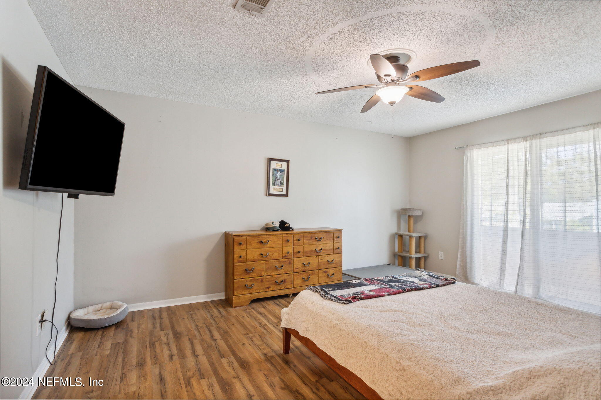 1154 Penman Road Jacksonville Beach, FL 32250 - Photo 10 of 20 a bedroom with a bed and a flat screen tv
