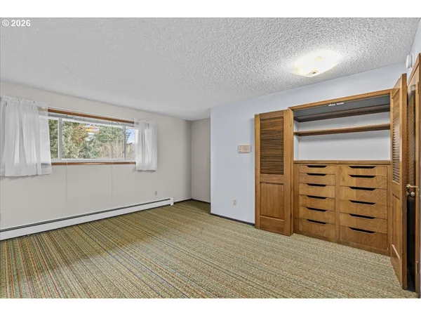 a view of an empty room with a closet