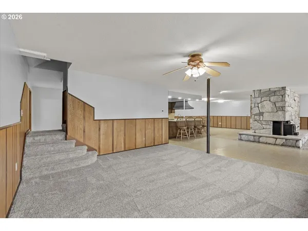 a view of an empty room with a kitchen