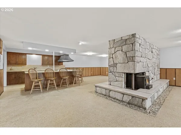 a living room with furniture a table and kitchen view