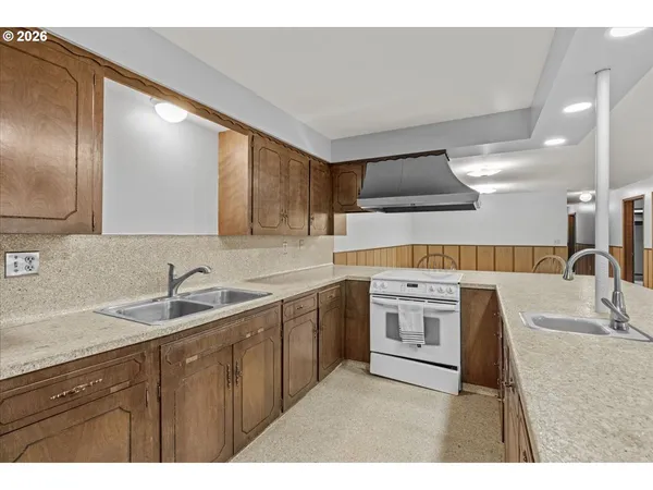 a kitchen with kitchen island granite countertop a sink and cabinets