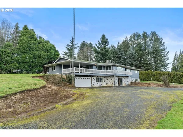 a view of a house with pool and a yard