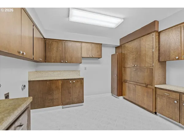 a kitchen with a refrigerator and cabinets
