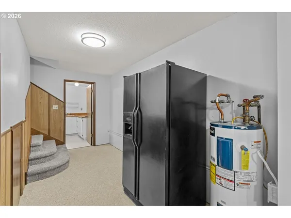 a kitchen with stainless steel appliances granite countertop a refrigerator and a stove