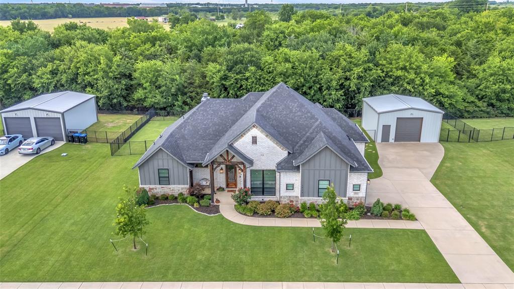 1014 Rennard Street Caddo Mills, TX 75135 - Photo 34 of 39 Aerial view of exterior of home on oversized, tree-lined lot featuring large workshop and extended driveway