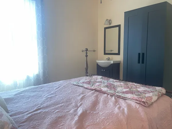 a bedroom with a bed and a mirror