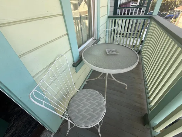 a balcony with table and chairs