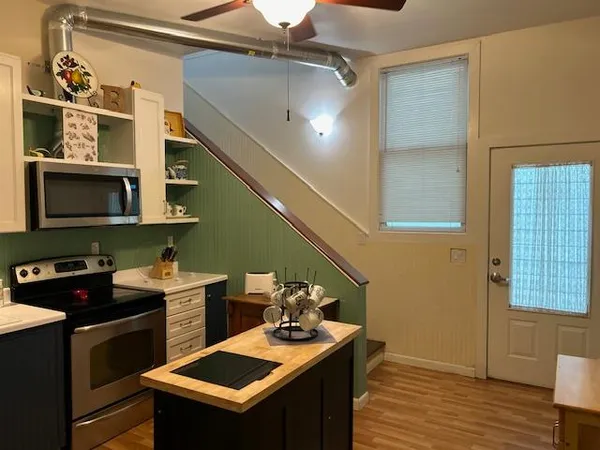 a kitchen with a sink a stove and cabinets