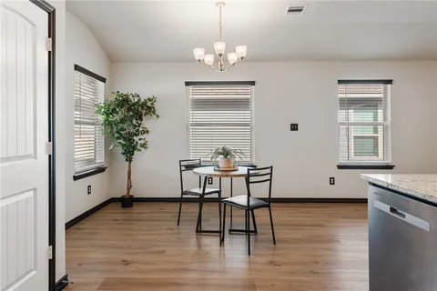 a view of a dining room with furniture and window