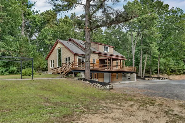 a view of a house with a yard balcony and sitting area