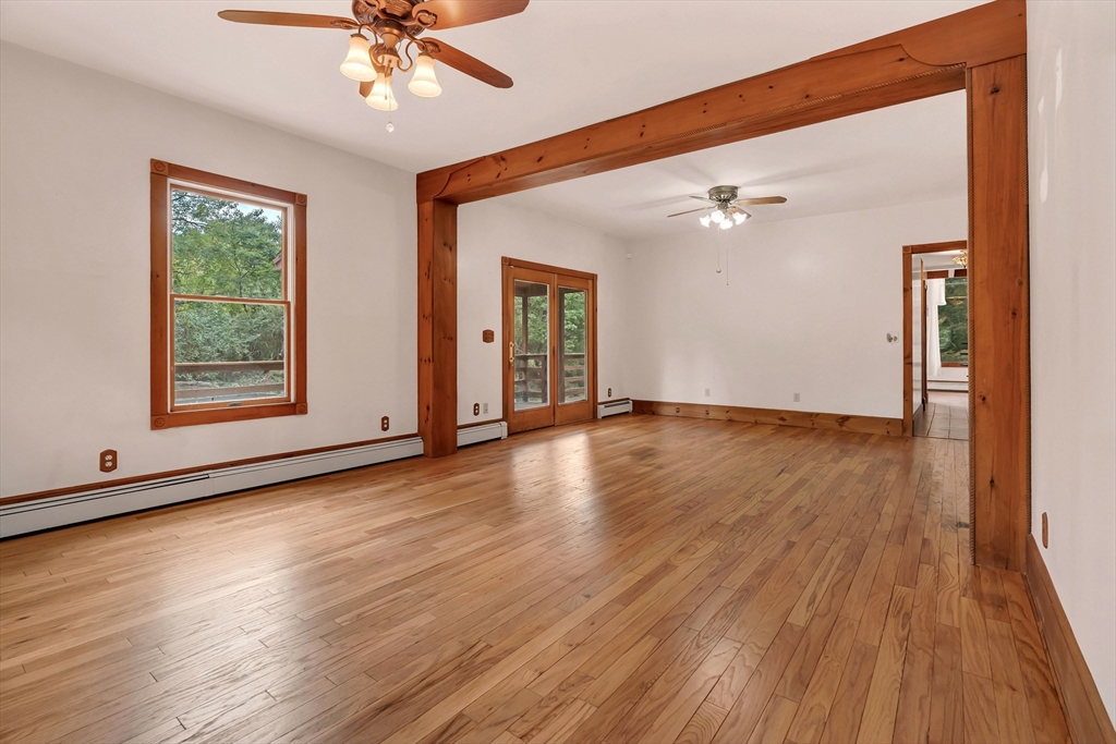 49 R Elm Street Blackstone, MA 01504 - Photo 11 of 42 a view of an empty room with wooden floor and a window