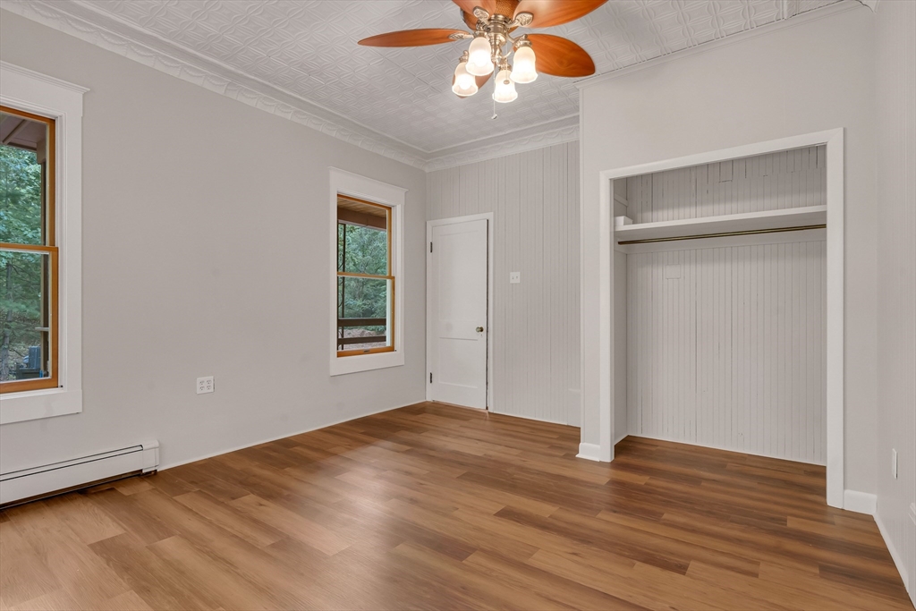 49 R Elm Street Blackstone, MA 01504 - Photo 16 of 42 a view of an empty room with wooden floor and a window