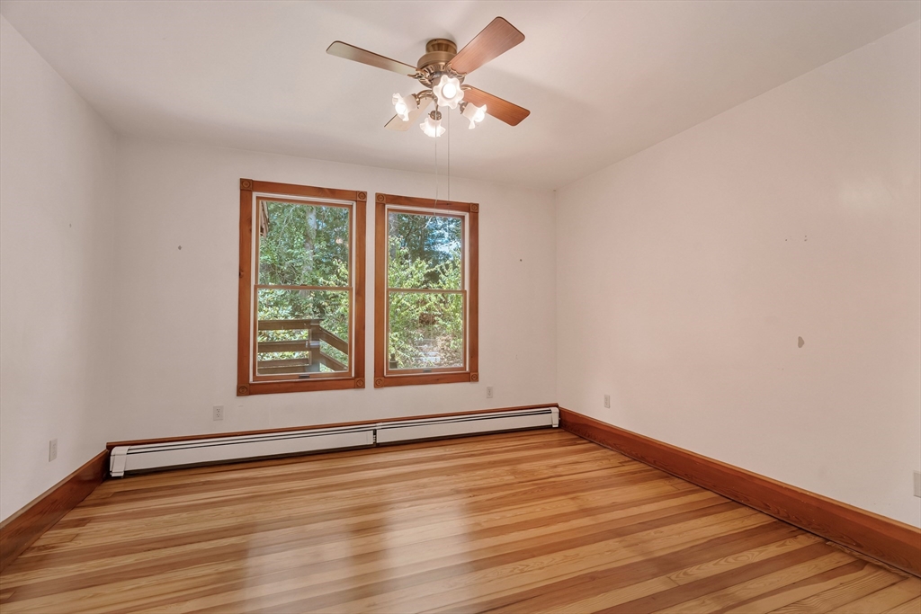 49 R Elm Street Blackstone, MA 01504 - Photo 17 of 42 a view of an empty room with wooden floor and a window