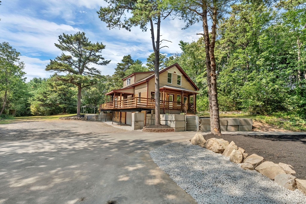 49 R Elm Street Blackstone, MA 01504 - Photo 2 of 42 a front view of a house with a yard and trees