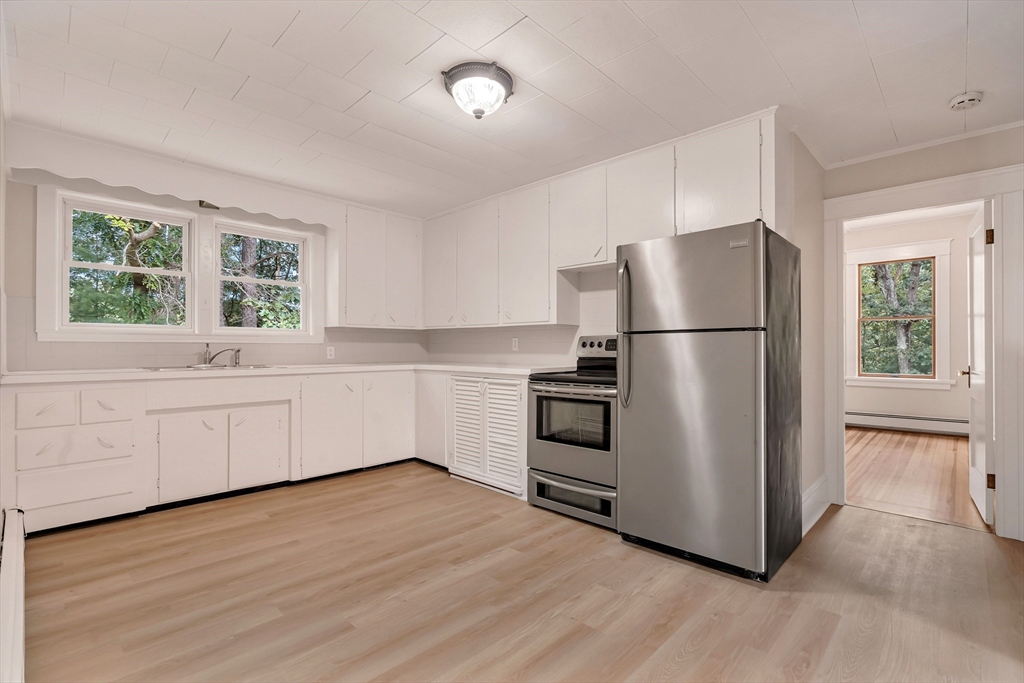 49 R Elm Street Blackstone, MA 01504 - Photo 30 of 42 a kitchen with a refrigerator wooden floor and window