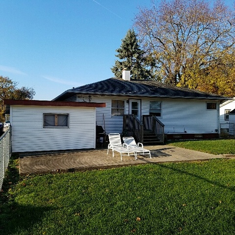 623 South 3rd Street Rochelle, IL 61068 - Photo 3 of 12 a backyard of a house with table and chairs