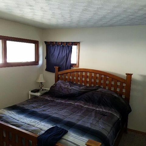 623 South 3rd Street Rochelle, IL 61068 - Photo 7 of 12 a bed sitting in a bedroom next to a window