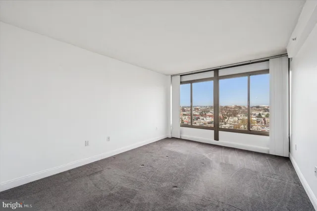 an empty room with large windows