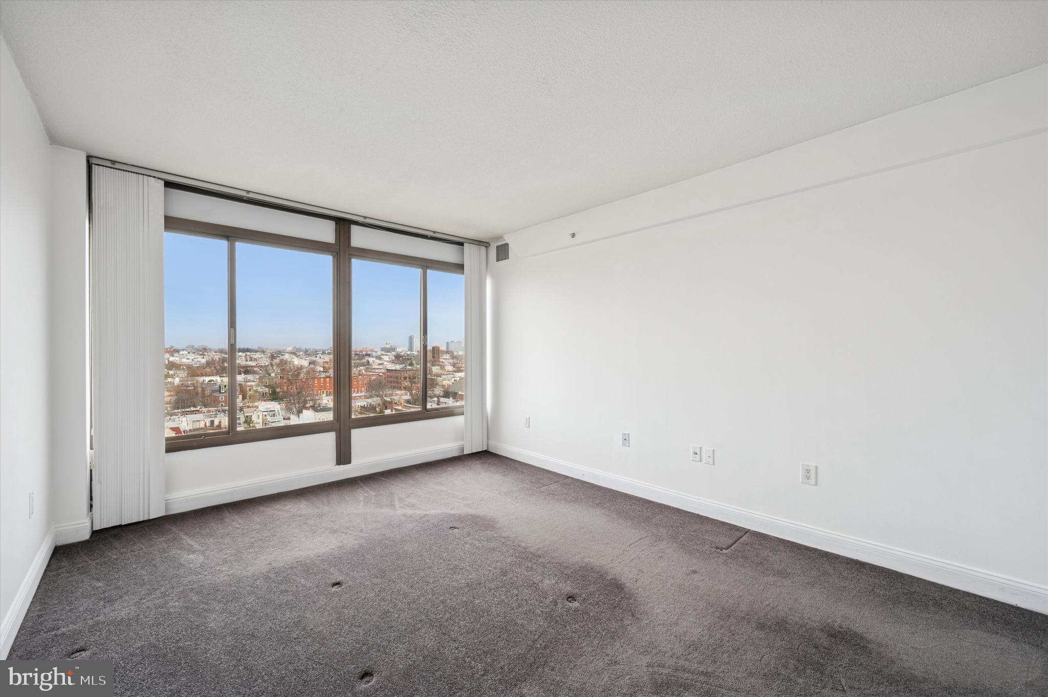 2001 Hamilton Street, Unit 1221 Philadelphia, PA 19130 - Photo 14 of 27 an empty room with large windows