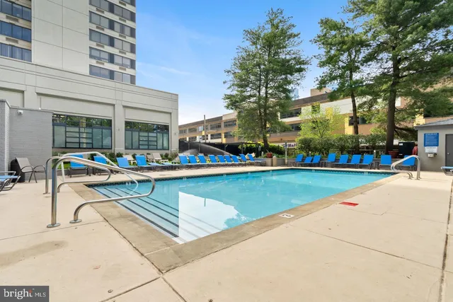 a view of a building with a swimming pool and sitting area
