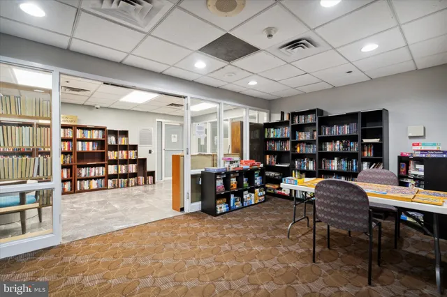 a living room with lots of furniture and a book shelf