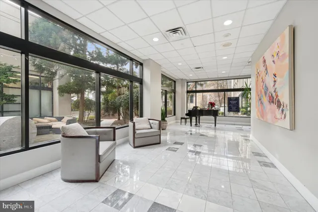 a living room with furniture and large windows