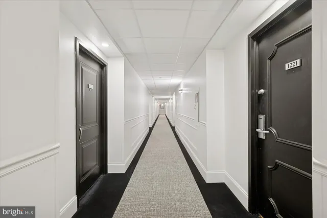 a view of a hallway with a window and a glass door