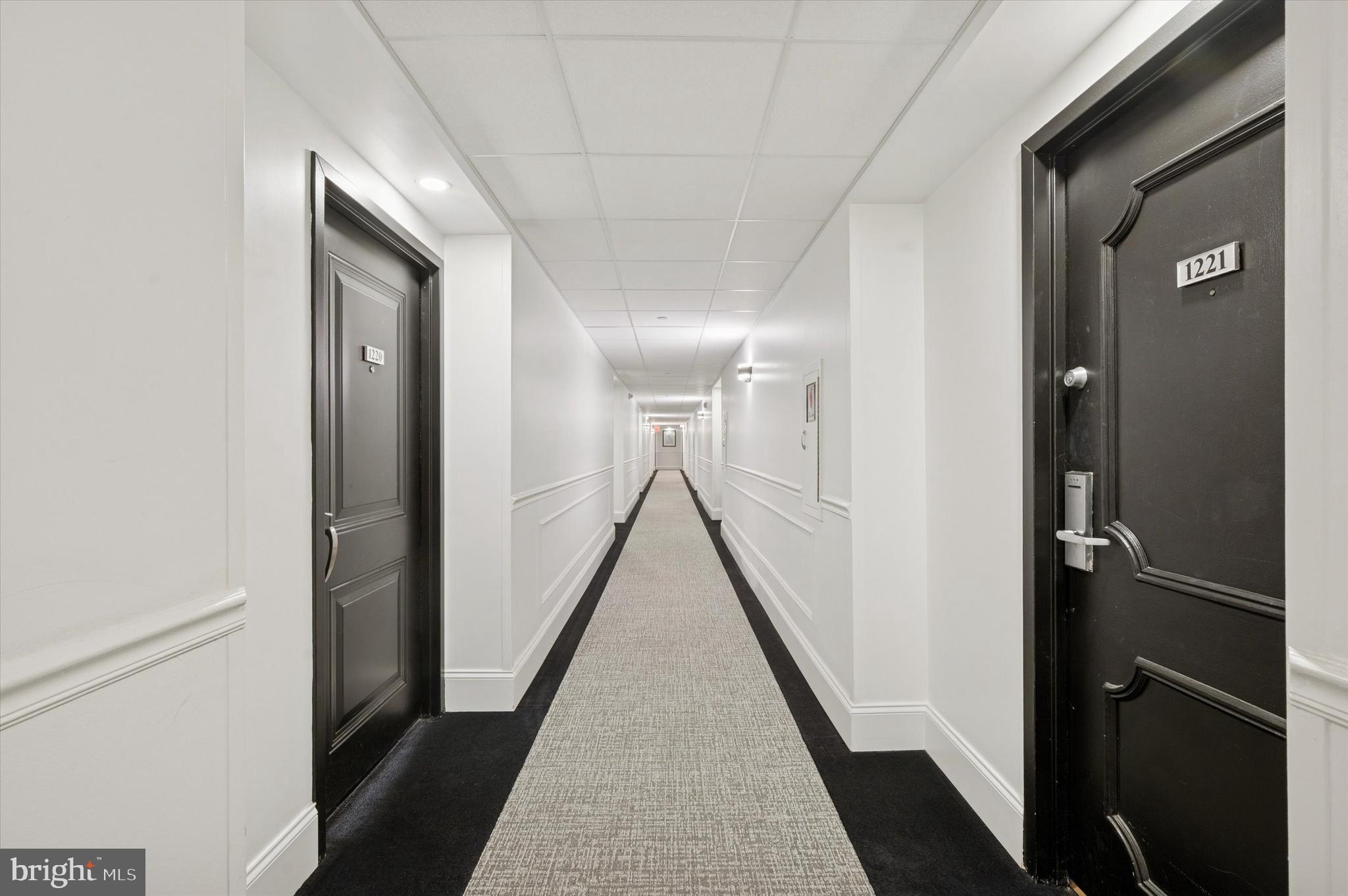 2001 Hamilton Street, Unit 1221 Philadelphia, PA 19130 - Photo 5 of 27 a view of a hallway with a window and a glass door