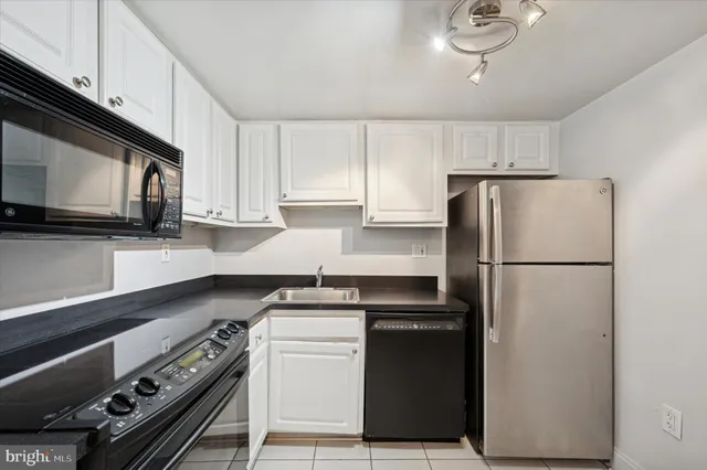 a kitchen with a refrigerator stove and microwave