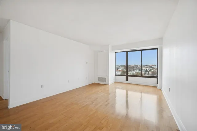 a view of a room with wooden floor and a window