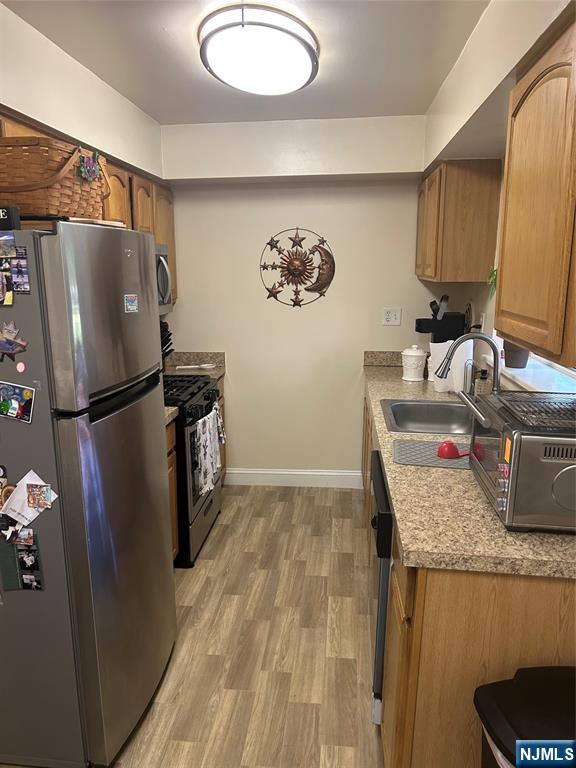 280-320 Oak Street, Unit 280A Ridgewood, NJ 07450 - Photo 2 of 24 a kitchen with a refrigerator and countertop