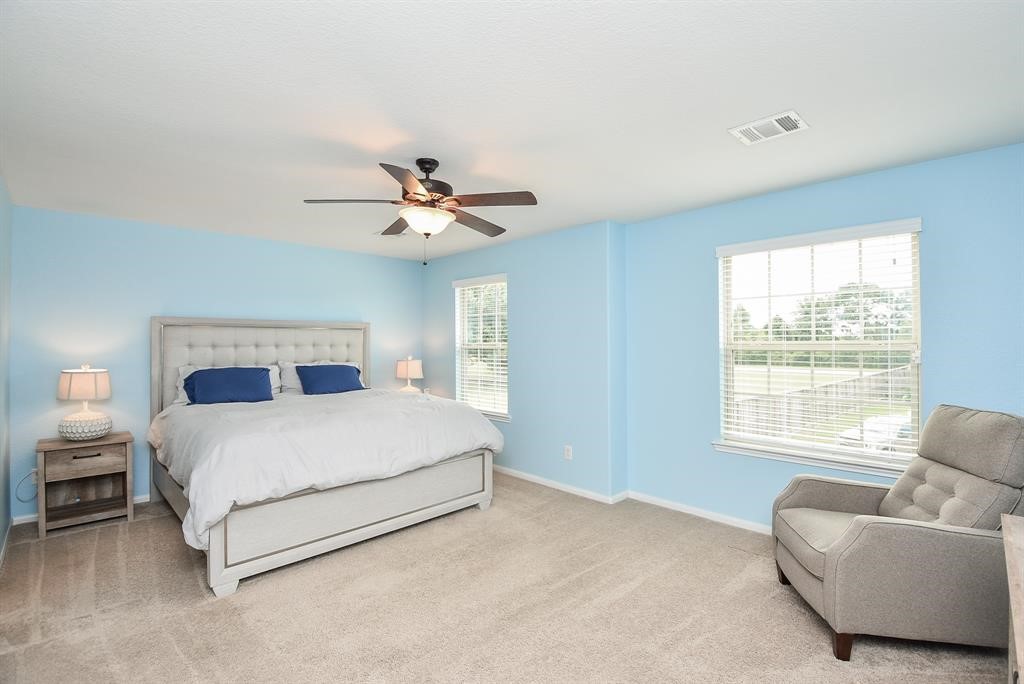 7002 Edwanna Lane Spring, TX 77389 - Photo 9 of 17 a bedroom with a bed chandelier and window