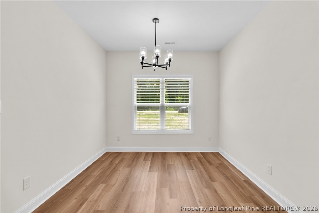 131 Merle Road Pinebluff, NC 28373 - Photo 16 of 33 wooden floor in an empty room with a window