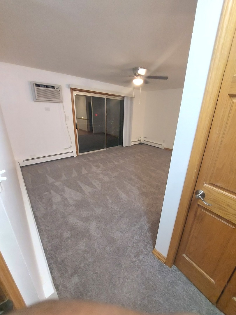 903 Elder Road, Unit 11 Homewood, IL 60430 - Photo 2 of 9 an empty room with a fireplace and painted walls