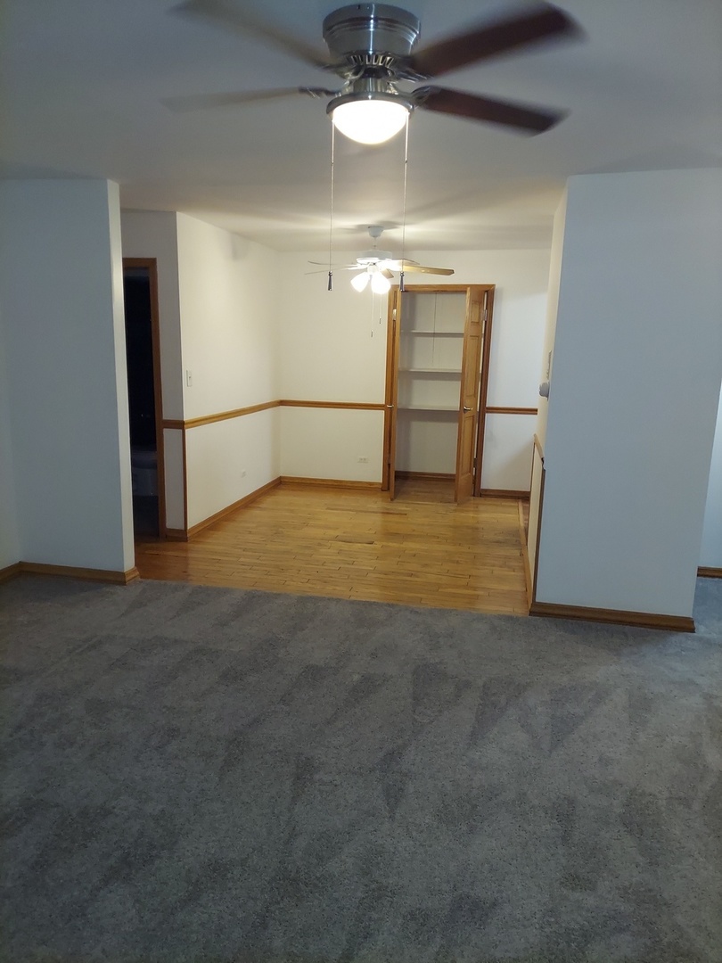 903 Elder Road, Unit 11 Homewood, IL 60430 - Photo 3 of 9 a view of an empty room with a chandelier fan