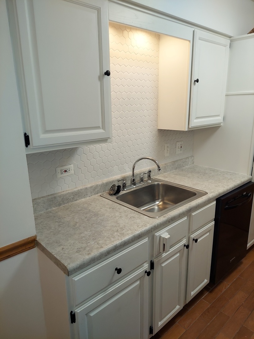 903 Elder Road, Unit 11 Homewood, IL 60430 - Photo 6 of 9 a kitchen with granite countertop white cabinets and a sink