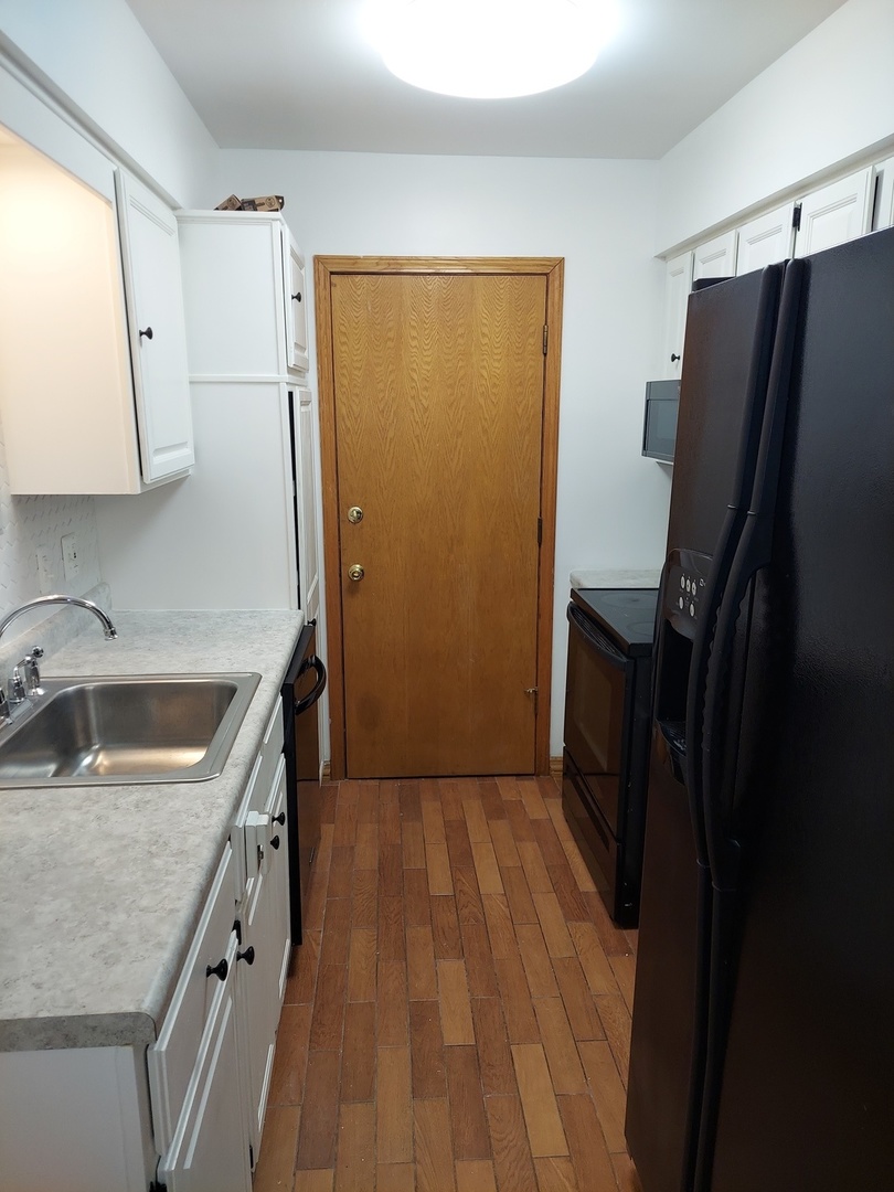 903 Elder Road, Unit 11 Homewood, IL 60430 - Photo 8 of 9 a kitchen with a refrigerator sink and stove