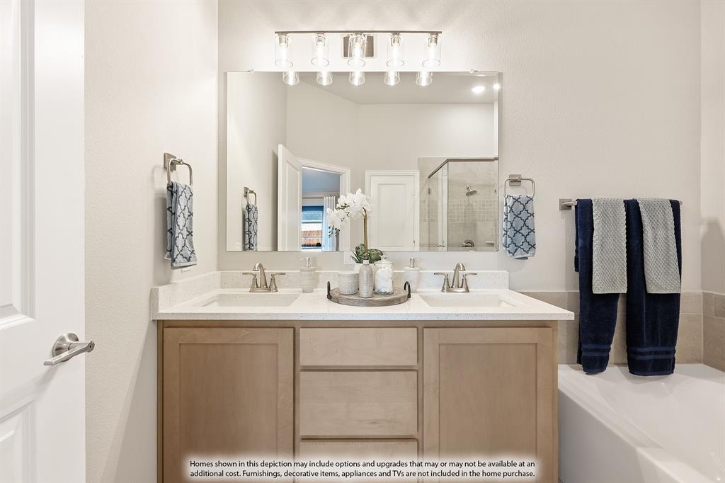 14550 Lovelace Street Pilot Point, TX 76258 - Photo 19 of 23 a bathroom with a sink vanity and a mirror