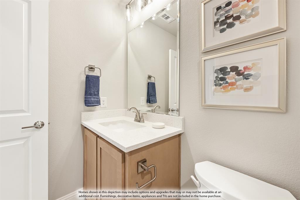 14550 Lovelace Street Pilot Point, TX 76258 - Photo 23 of 23 a bathroom with a sink a toilet and a mirror