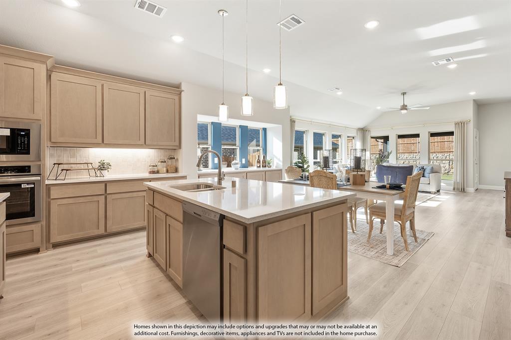14550 Lovelace Street Pilot Point, TX 76258 - Photo 4 of 23 a kitchen with a sink cabinets and wooden floor