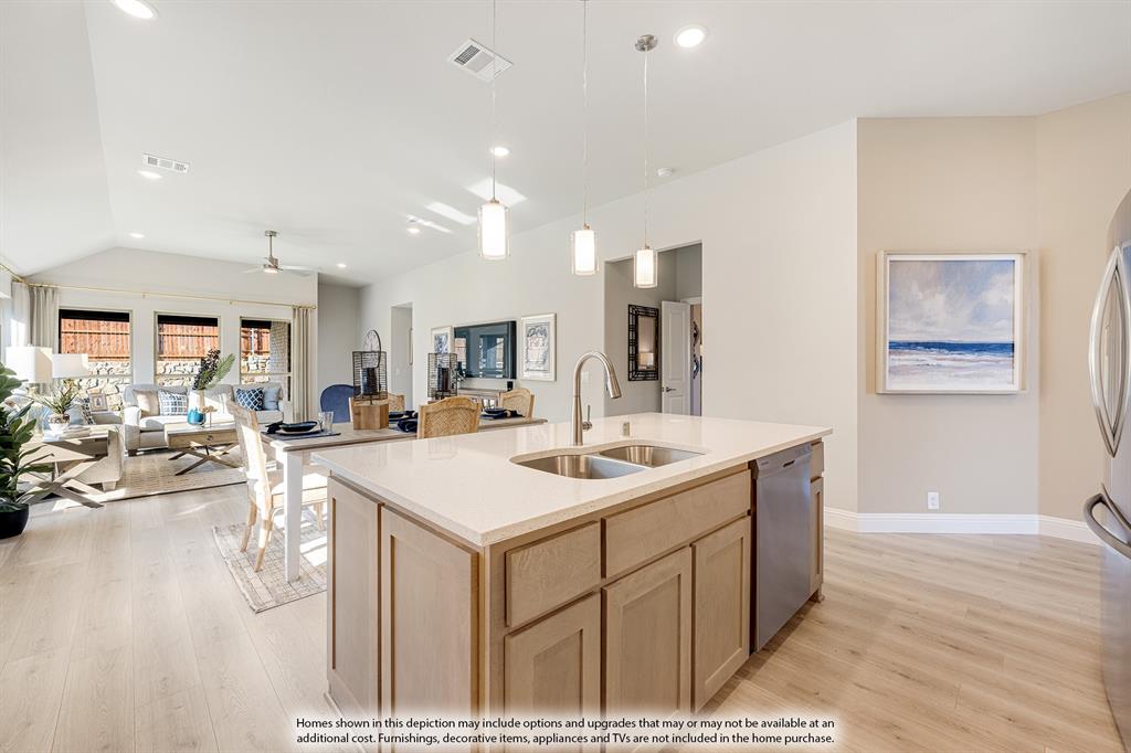 14550 Lovelace Street Pilot Point, TX 76258 - Photo 6 of 23 a large kitchen with kitchen island a sink a stove a dining table and chairs