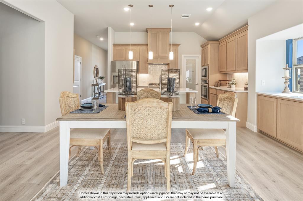 14550 Lovelace Street Pilot Point, TX 76258 - Photo 10 of 23 a kitchen with a dining table chairs and wooden floor