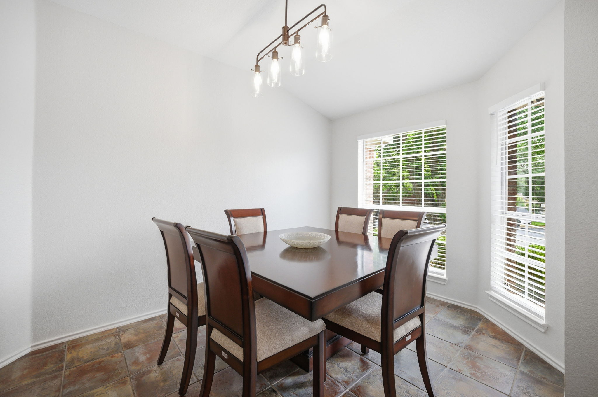 9024 Heiden Lane Austin, TX 78749 - Photo 3 of 28 Dining space with vaulted ceiling and multi-toned tile flooring